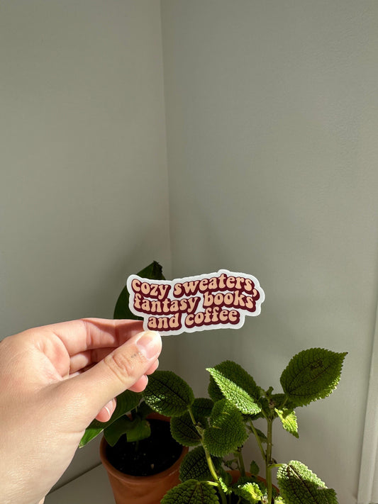 Cozy sweaters, fantasy books and coffee sticker